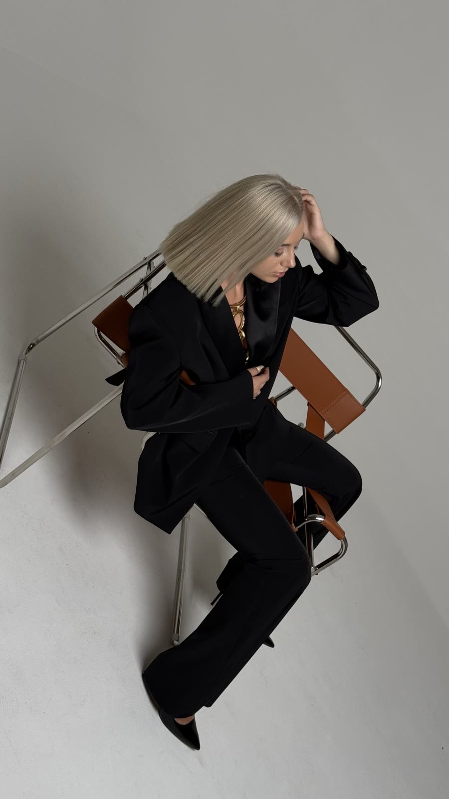 Kristina Strilets in a black suit on a light background