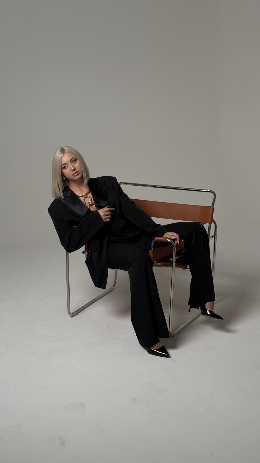 Kristina Strilets sitting on a leather chair