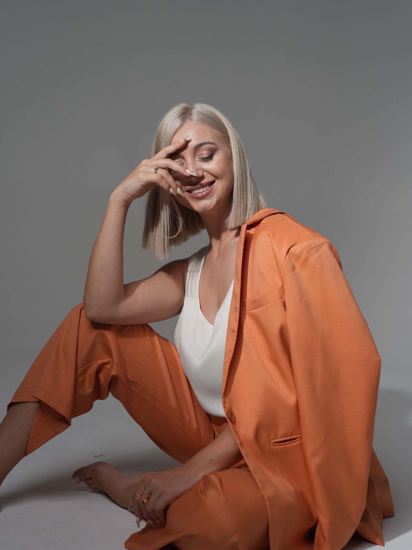 Kristina Strilets smiling in an orange suit