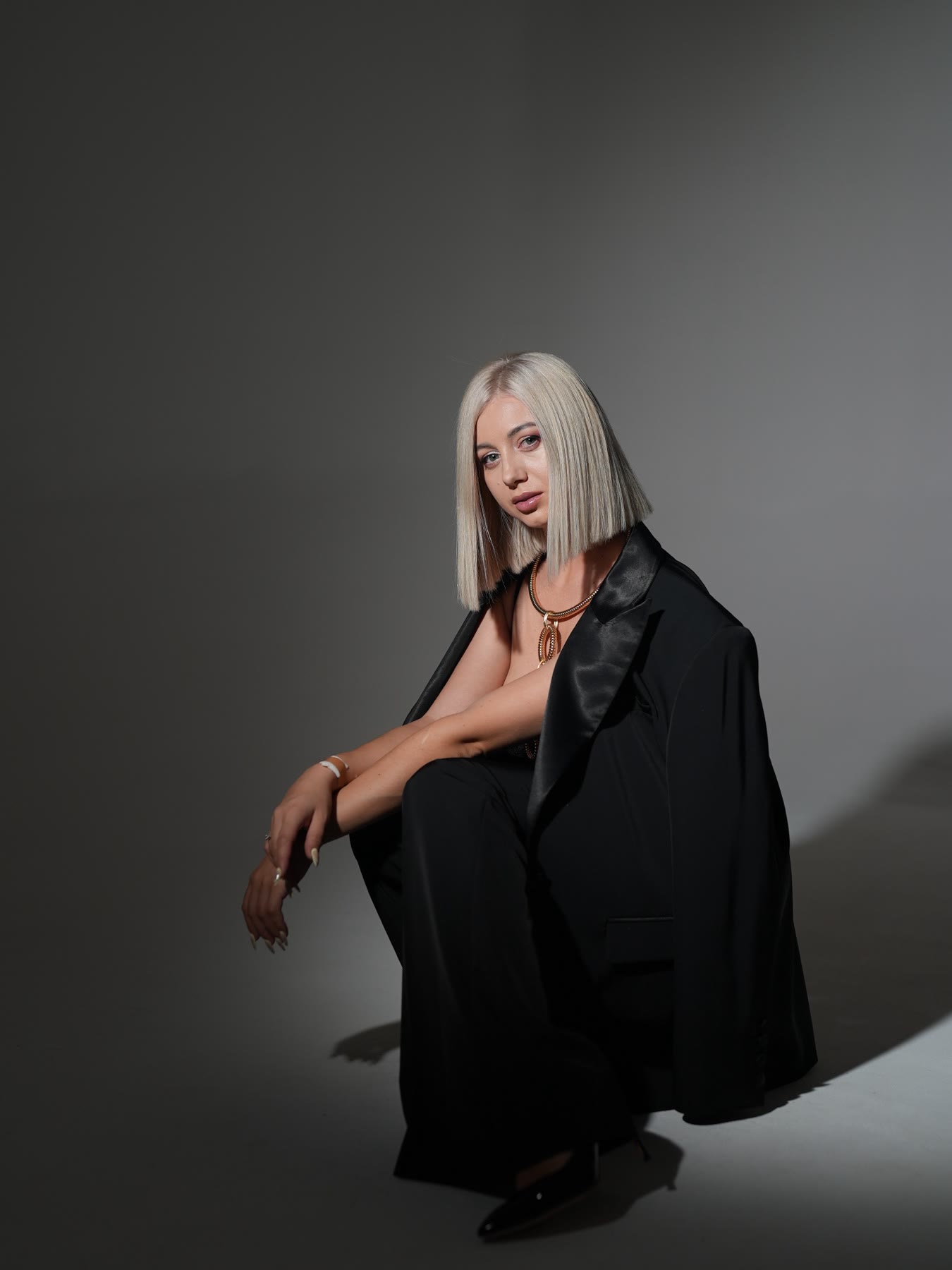 Portrait of nail educator Kristina Strilets in a black suit