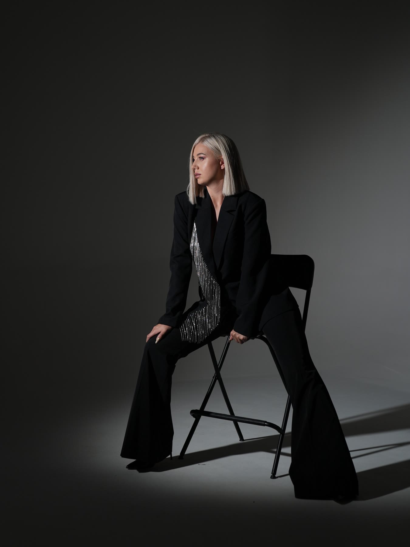 Kristina Strilets seated in a photo studio, editorial portrait
